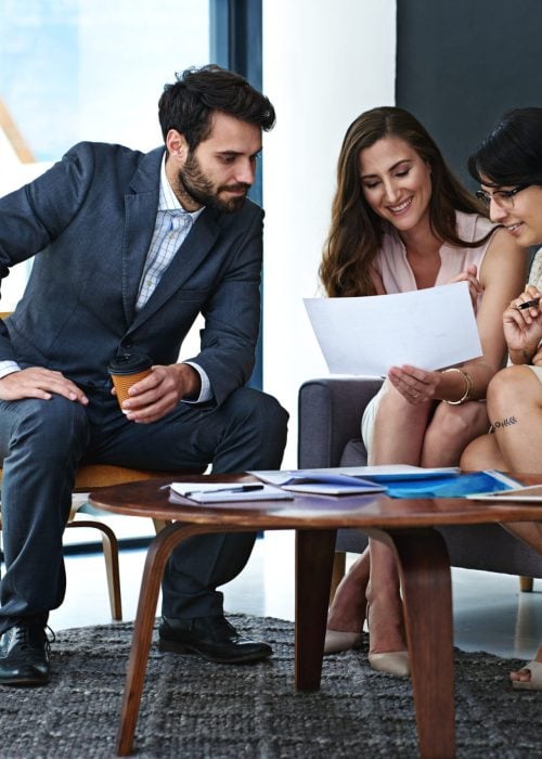 business-people-team-meeting-with-documents-project-planning-brainstorming-discussion-office-group-happy-employees-with-paperwork-collaboration-report-review-workplace (1)